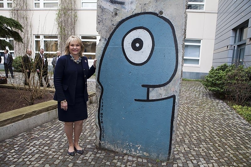 Governor Mary Fallin with a work by Thierry Noir, painted on a piece of the Berlin Wall