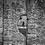 Echoes of the Ages: How Berlin's urban scars shape the contemporary art and culture landscape. 20th-century wall decor View through the Berlin Wall